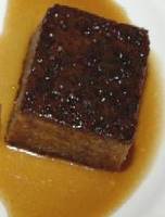 a piece of sticky toffee pudding on a plate